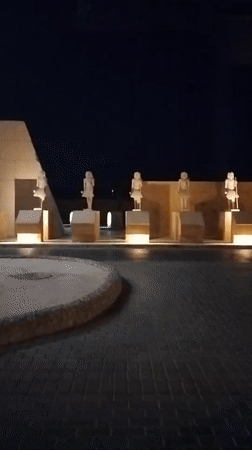 Illuminated Egyptian monuments and statues observed at night display