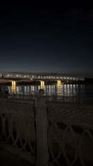Nighttime bridge and waterfront lights captured in Rusanovo, Russia