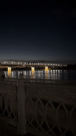 Nighttime bridge and waterfront lights captured in Rusanovo, Russia
