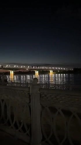 Nighttime bridge and waterfront lights captured in Rusanovo, Russia