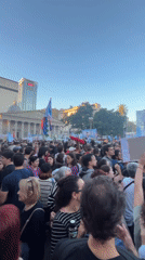 Crowd gathers with signs, flags in Buenos Aires square