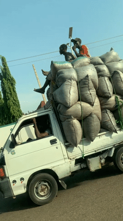 White truck carries sacks along road in Nigeria