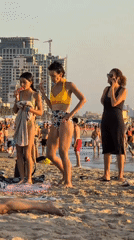 Late afternoon crowd and sunset on a Tel Aviv beach