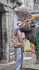Rainy morning at a Mandi temple, street life in motion