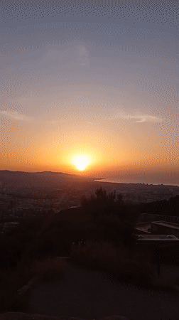 Barcelona sunset watched from the hills, city and sea below