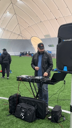 DJ provides music at children's indoor soccer session