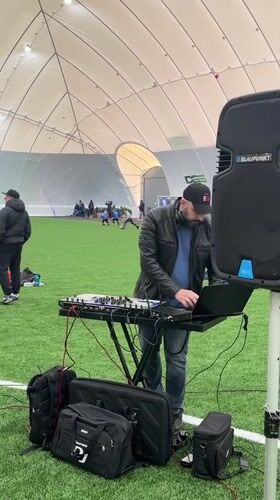 DJ provides music at children's indoor soccer session