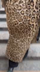 Commuter in leopard coat walks subway platform in Sankt-Peterburg