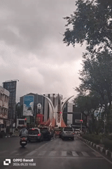 Morning traffic flows through rainy Banda Aceh intersection