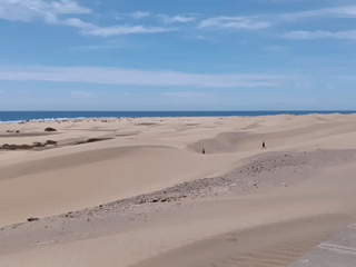 Tourists capture scenic Maspalomas Dunes views in Gran Canaria