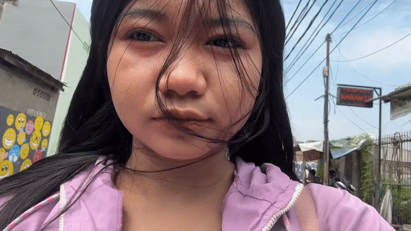 Woman records selfie videos on North Jakarta street