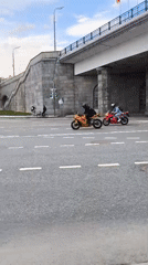 Two colorful motorcycles ride together on Moscow street