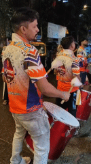 Drum procession and festive street lights in nighttime Mumbai