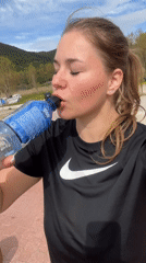 Woman hydrates outdoors in Montenegro mountain setting