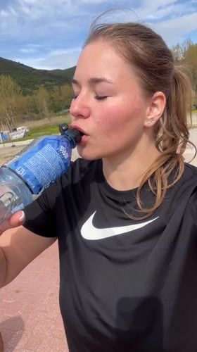 Woman hydrates outdoors in Montenegro mountain setting