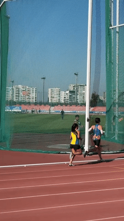 Woman competes in discus throw at Santiago athletics stadium