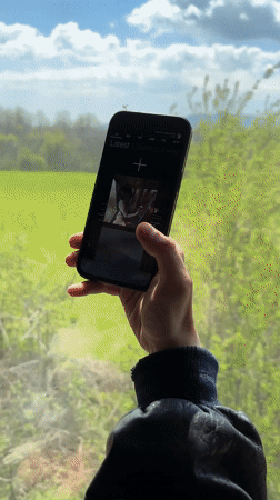Person photographs railroad tracks with smartphone in Anevo, Bulgaria
