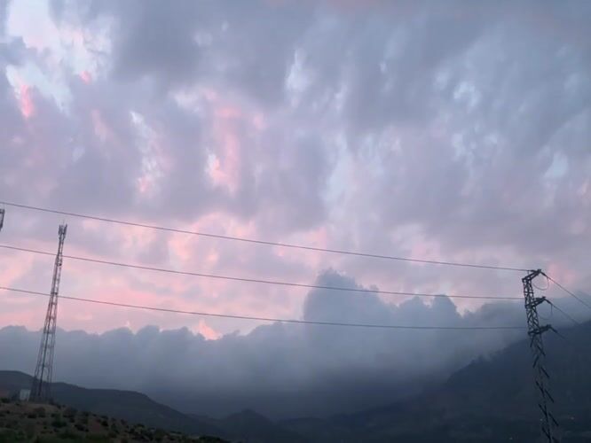 Pink dusk sky captured over Ouaouizert mountains and towers