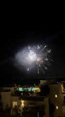 Fireworks display over Sorrento resort, multiple rooftop angles
