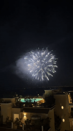 Fireworks display over Sorrento resort, multiple rooftop angles