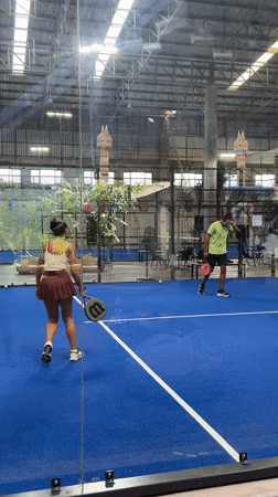 Indoor padel match on a blue court in northern Thailand