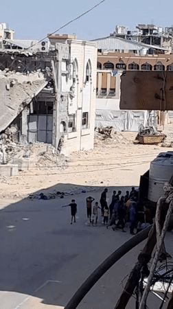 Residents collect water from a truck in Khan Yunis