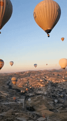Balloon flight over Cappadocia's rock formations at sunrise