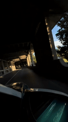 Vehicle travels through concrete tunnel in Budva during afternoon