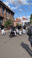 Street band performs with motorcycle-seated singer in Saarbrücken