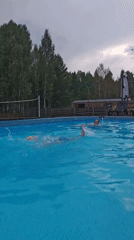 Casual afternoon swim in an outdoor pool on a cloudy day