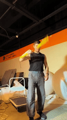 Martial arts weapons practice inside a Karaganda workshop space