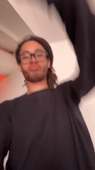 Person filmed making camera gestures in Paris workspace