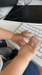 Baby plays with computer keyboard in Erba, Italy