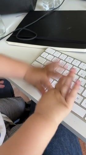 Baby plays with computer keyboard in Erba, Italy