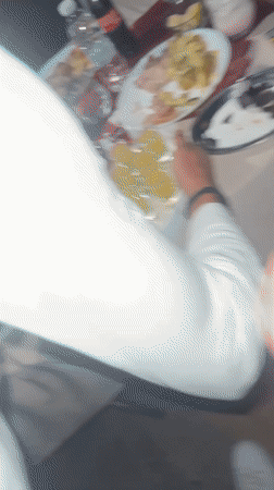 Young men celebrate with food and fireworks at night