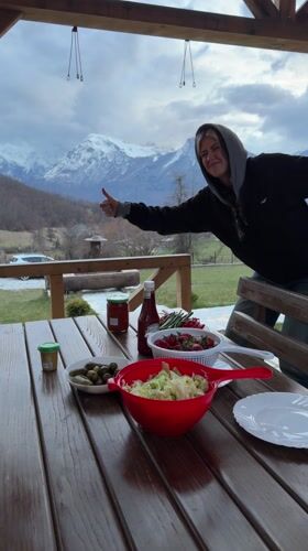 Friends gather for mountain-view barbecue meal in Montenegro