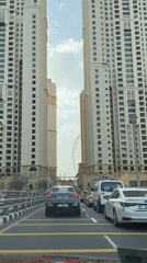 Heavy traffic flows through Dubai street amid apartment buildings