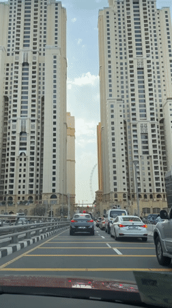 Heavy traffic flows through Dubai street amid apartment buildings