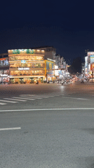 Busy nighttime street scene captured near Da Lat coffee shop