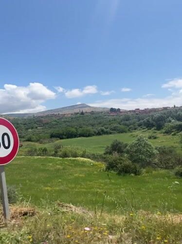 Motorcyclist travels through scenic Moroccan countryside, stops for fuel