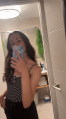 Woman takes bathroom selfie in Alicante, Spain