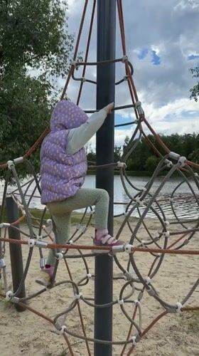 Child plays at lakeside playground in Malakhovka, Russia