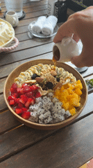 Honey drizzled over mixed fruit bowl in Vietnam