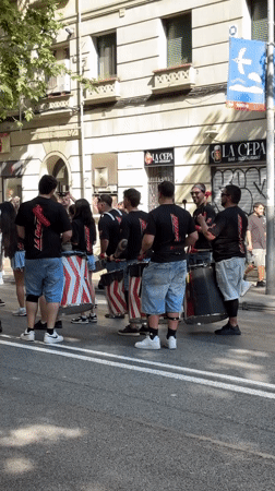 Street drummers perform in coordinated outfits in Barcelona