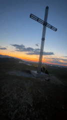 Sunset illuminates hilltop cross in Sinitovo, Bulgaria