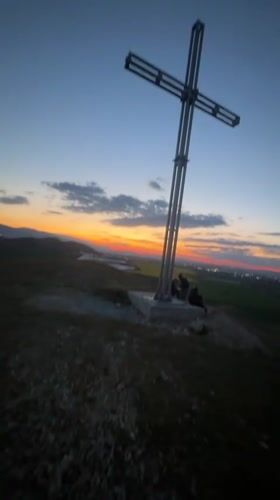 Sunset illuminates hilltop cross in Sinitovo, Bulgaria