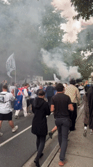 Flag-waving crowd with flares marches through Vancouver streets