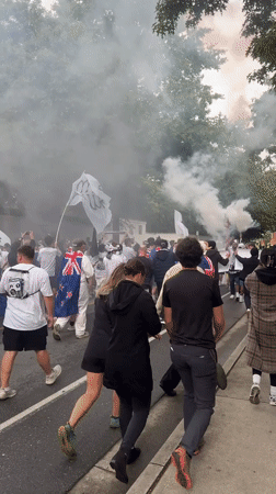 Flag-waving crowd with flares marches through Vancouver streets
