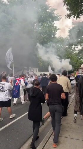 Flag-waving crowd with flares marches through Vancouver streets