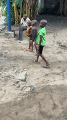 Children and elderly man gather in Ikot Ekpene yard